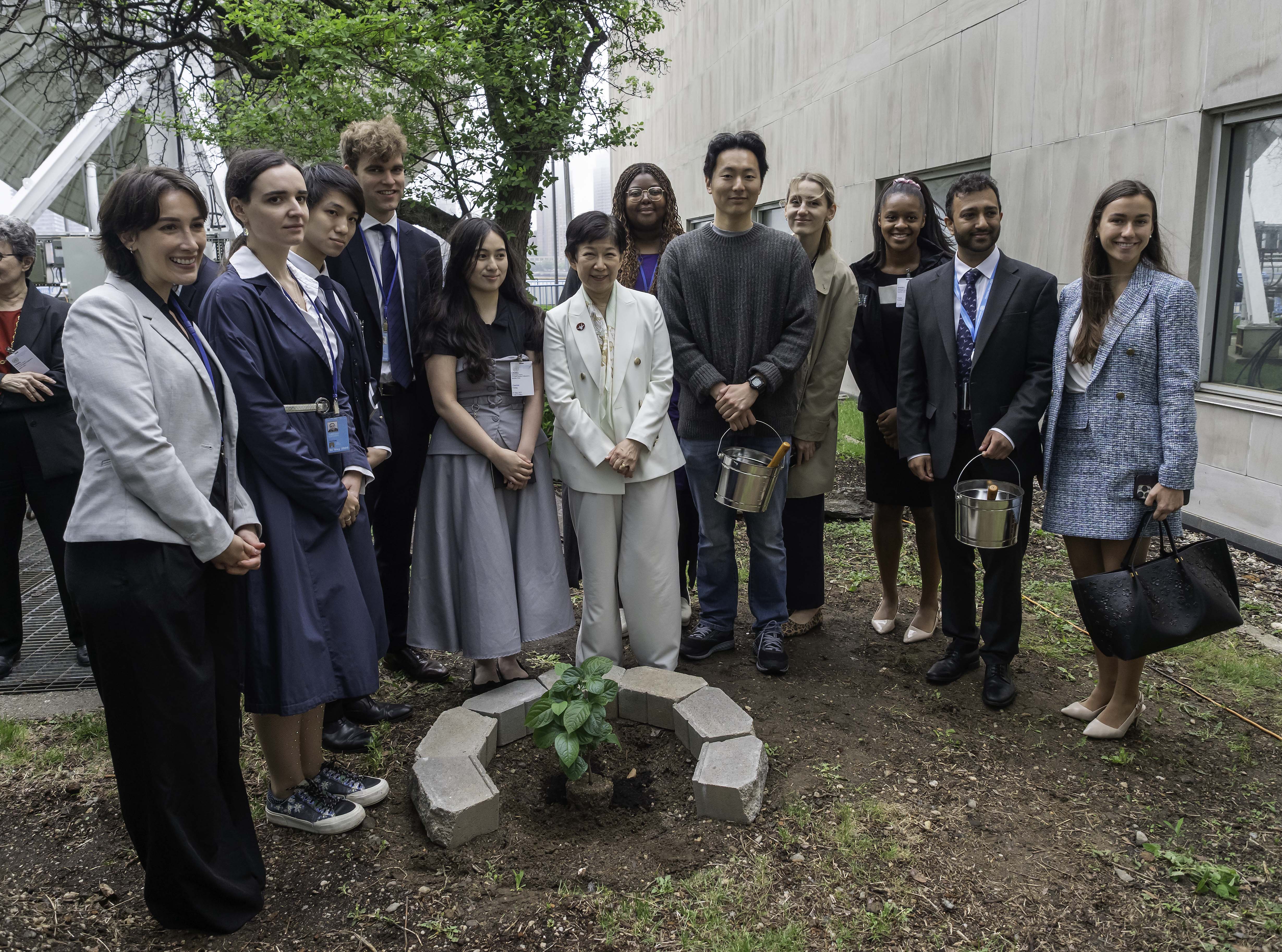High Representative for Disarmament Affairs, Izumi Nakamitsu and Charlotte Yeung together with young people at the tree planting ceremony