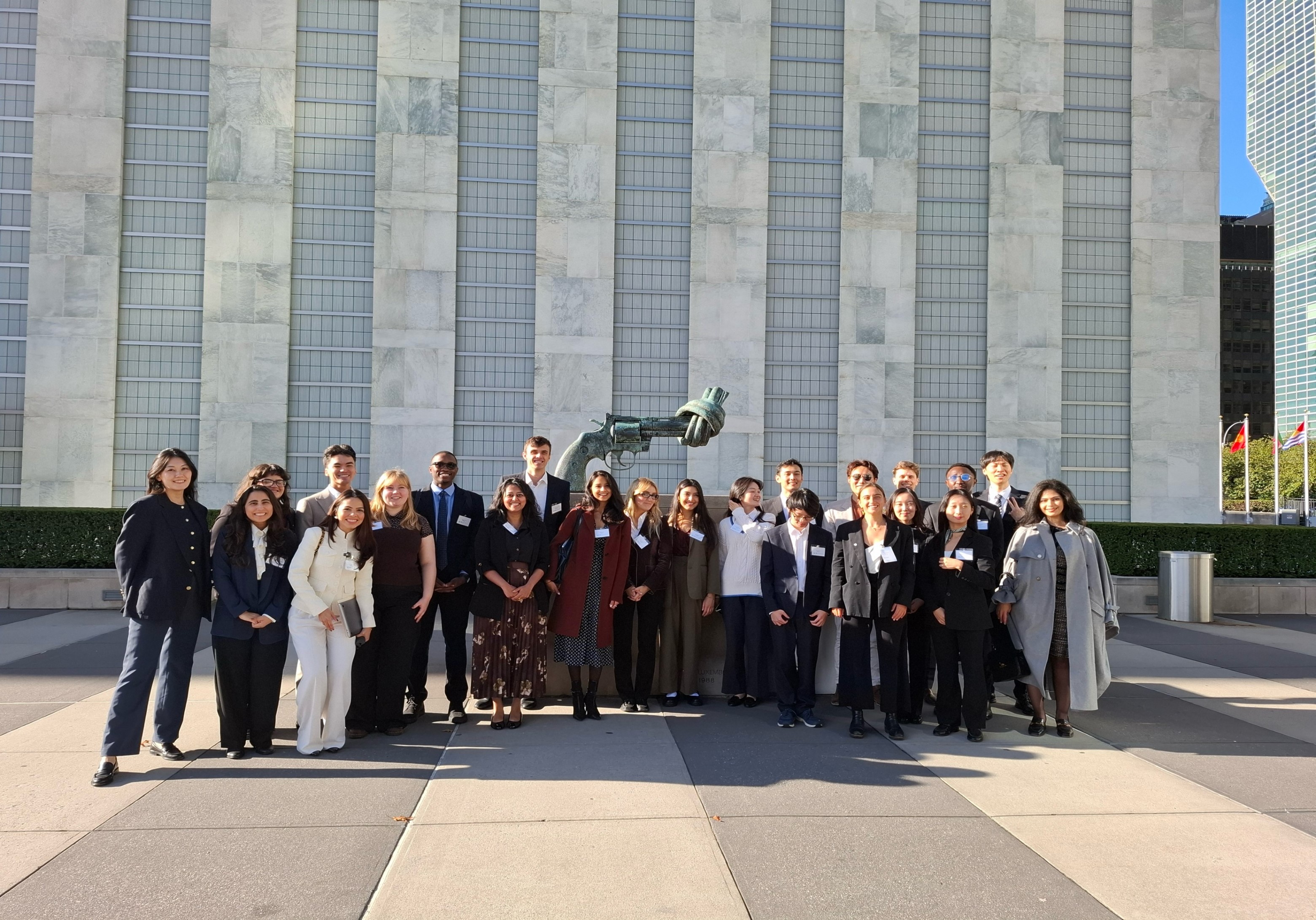 Y4D Forum participants in front of the Knotted Gun statue