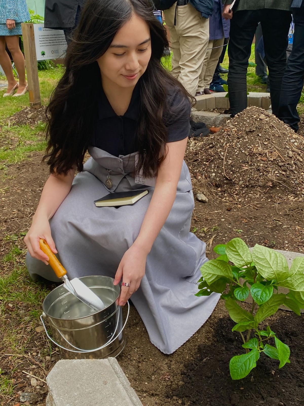 A person sitting on the ground with a bucket of water

AI-generated content may be incorrect., Picture