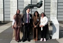 Youth Champions standing in front of the Knotted Gun statue
